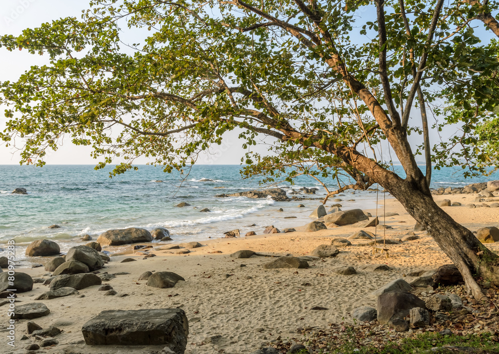 Rock beach with wooden swing in Thailand Rock beach with wooden swing in Thailand