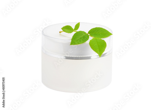 Cream can and green leaf, isolated on white background