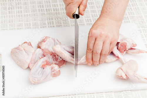 cutting raw chicken wings