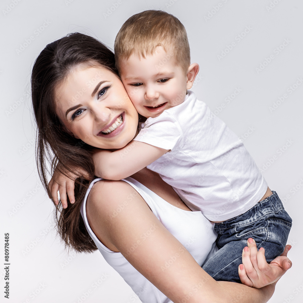 happy mother with a child on light grey background