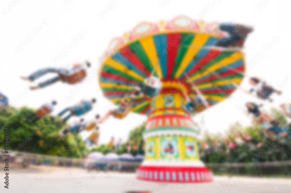 Blur background image of  roller swings in amusement park.