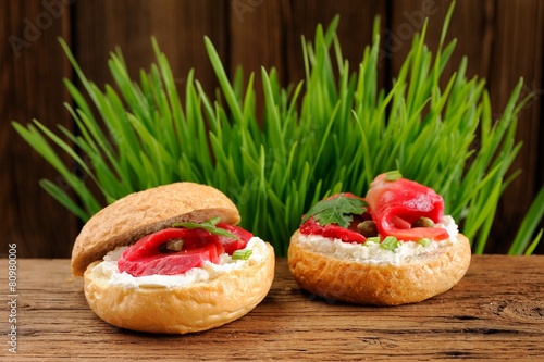 Sandwiches with gravlax, parsley, scallion, capers and cream che photo