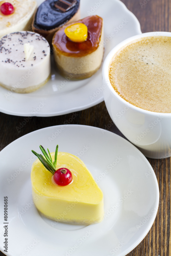Fototapeta premium delicious mini cakes and a cup of coffee