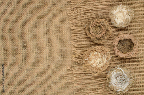 nest of thread on burlap background