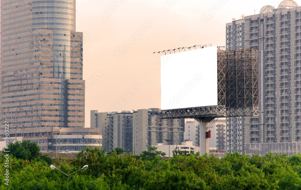 large blank billboard with city view background.