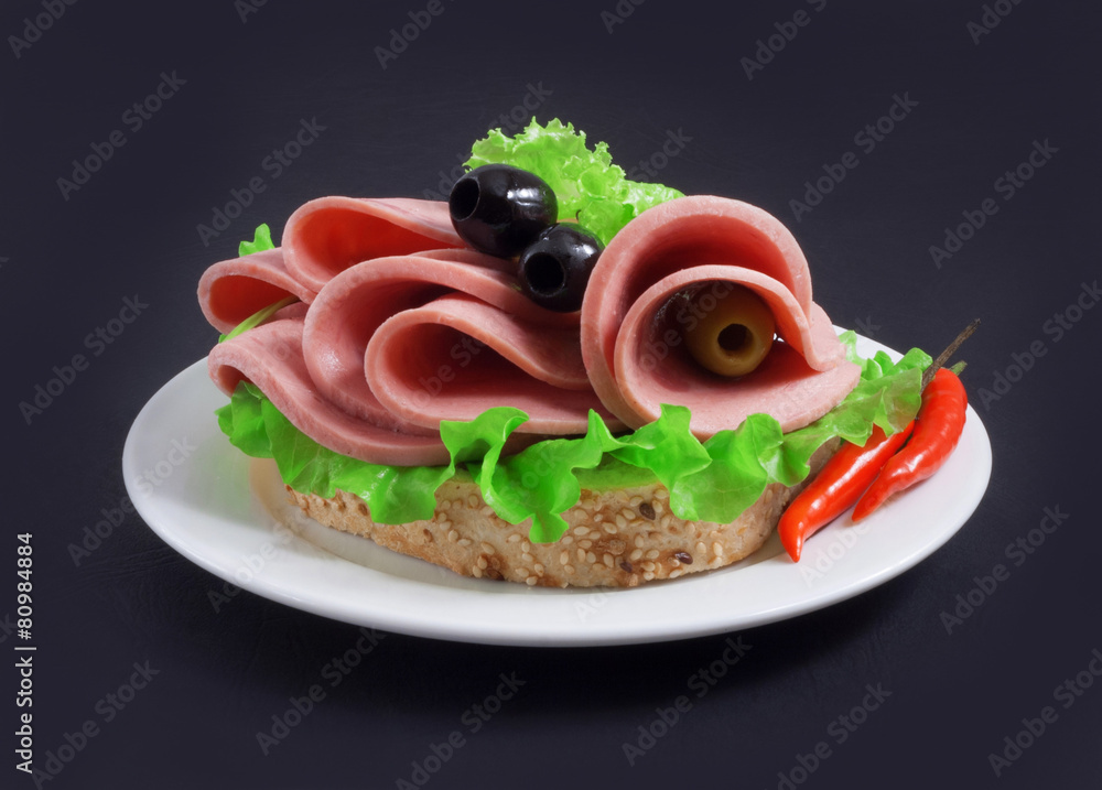 sandwich with vegetables, herbs and spices on a white plate