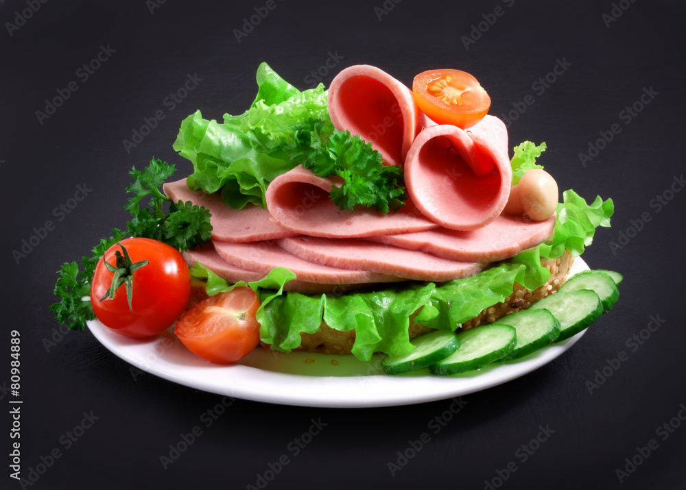 sandwich with vegetables, herbs and spices on a white plate sandwich with vegetables, herbs and spices on a white plate
