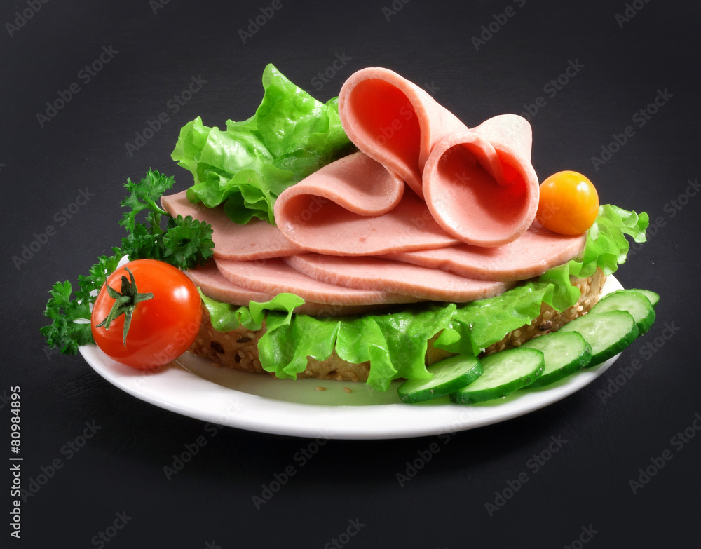 sandwich with vegetables, herbs and spices on a white plate sandwich with vegetables, herbs and spices on a white plate