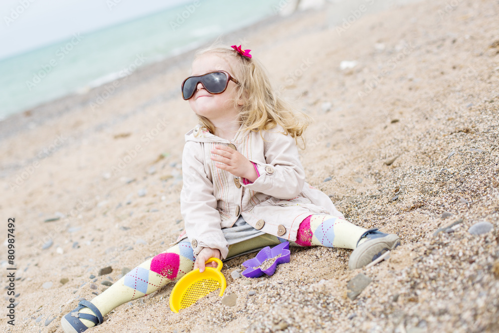Happy cute little girl playing on the beach Happy cute little girl playing on the beach