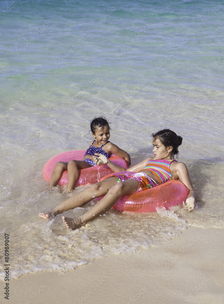 Fototapeta premium sisters with float tubes