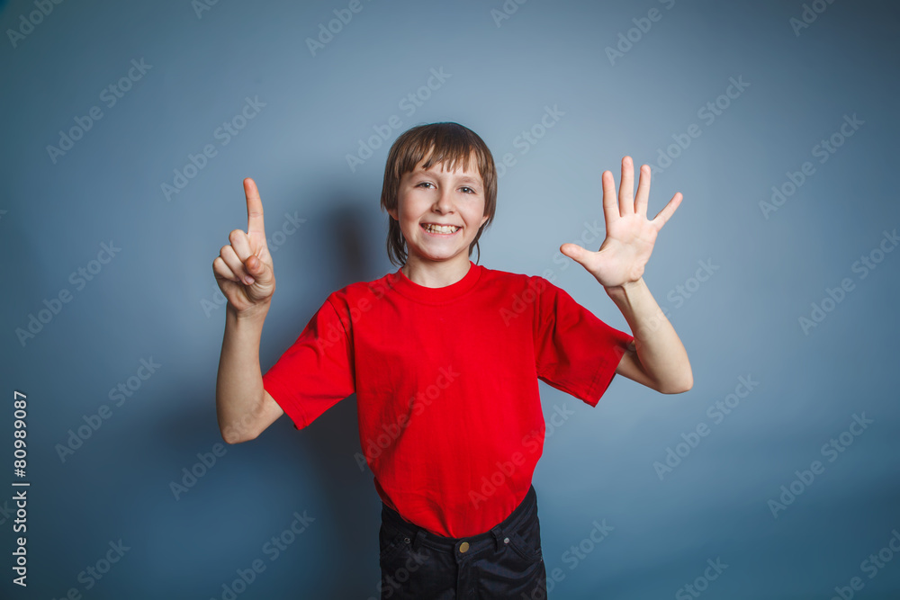 teenager boy brown European appearance in a red shirt shows the
