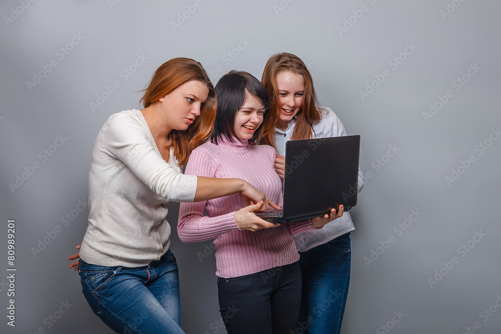 Three girls European appearance girlfriend looking at computer a Three girls European appearance girlfriend looking at computer a