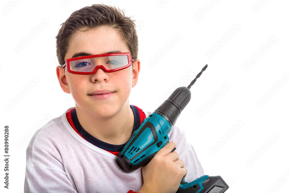 Soft skinned Child wearing red goggles and holding a cordless dr Soft skinned Child wearing red goggles and holding a cordless dr