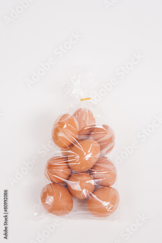 Eggs in a plastic bag on white paper background