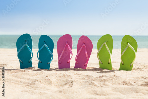 Pairs Of Flip-flops On Beach