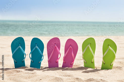 Pairs Of Flip-flops On Beach