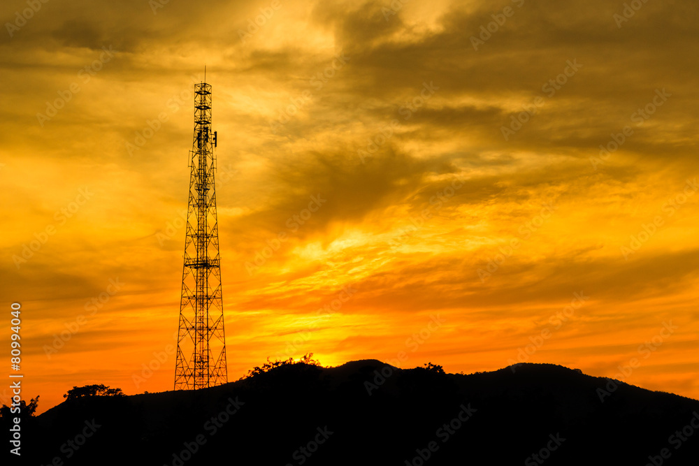 Telecommunications tower with sunset sky.