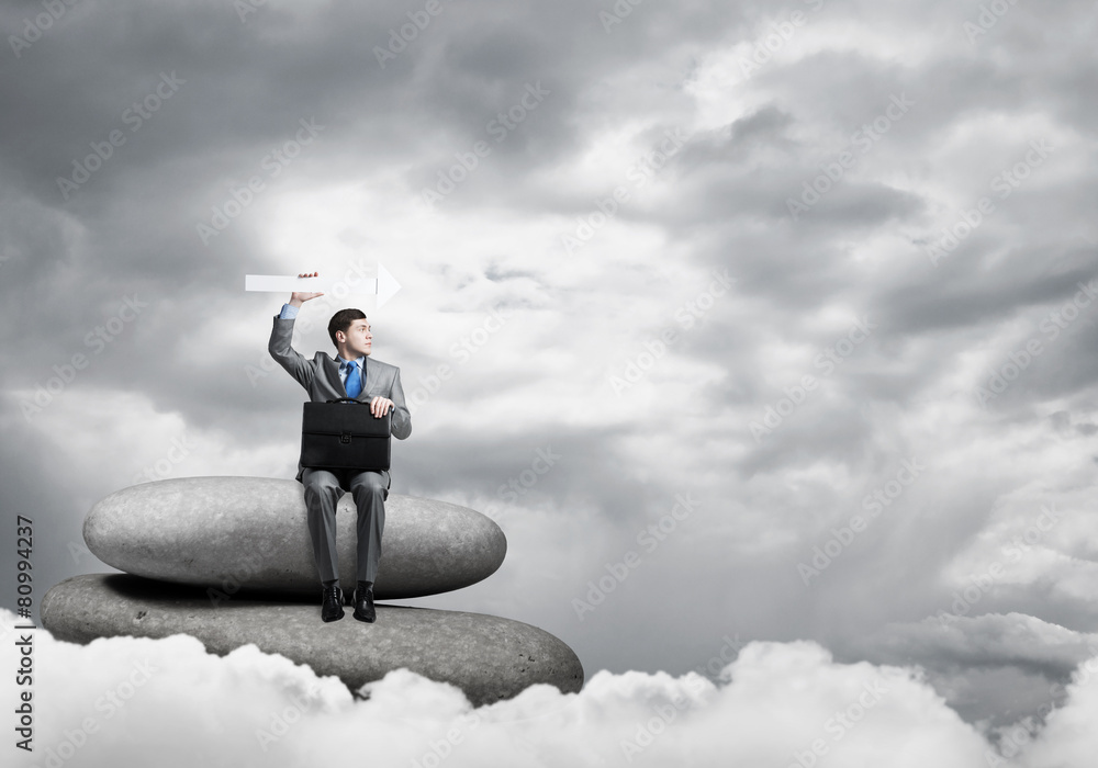 Businessman holding arrow