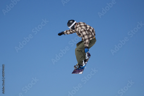 Snowboarder jumps in Snow Park