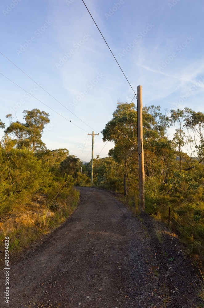 Australian Dirt Road with Electric Poles in Sunset Australian Dirt Road with Electric Poles in Sunset