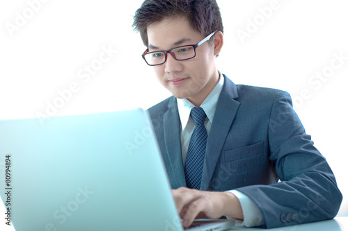 Handsome businessman working with laptop