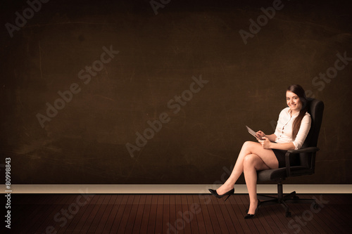 Businesswoman holding high tech tablet on background with copysp