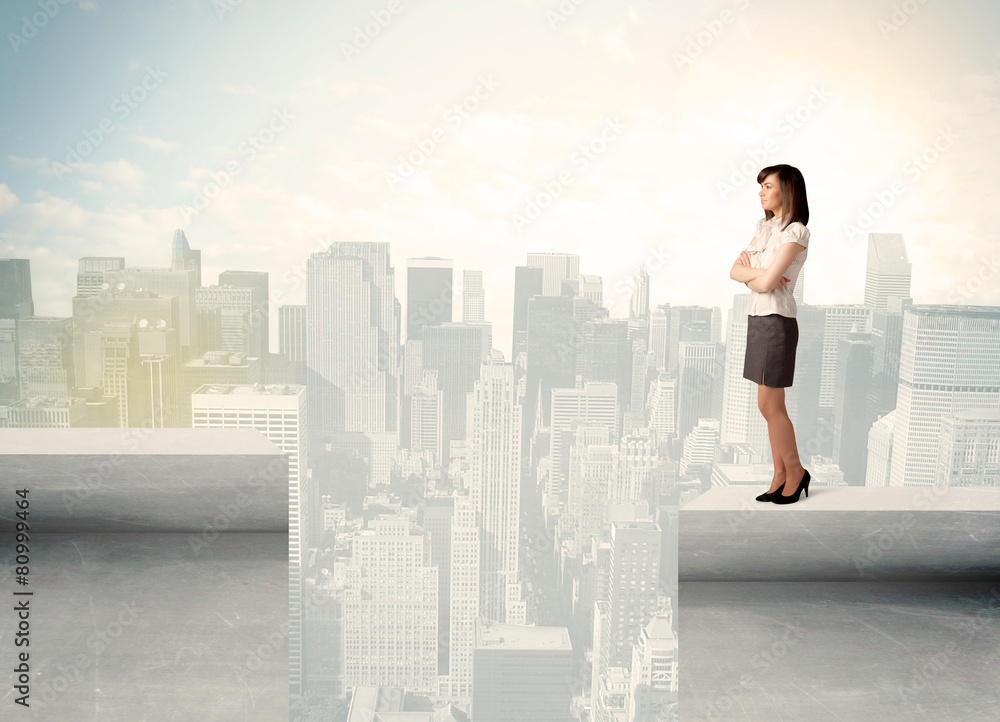 Businesswoman standing on the edge of rooftop Businesswoman standing on the edge of rooftop