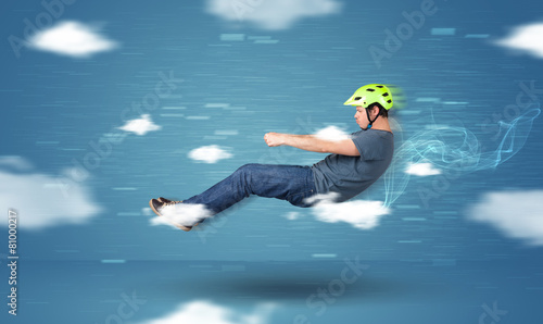 Funny racedriver young man driving between clouds concept