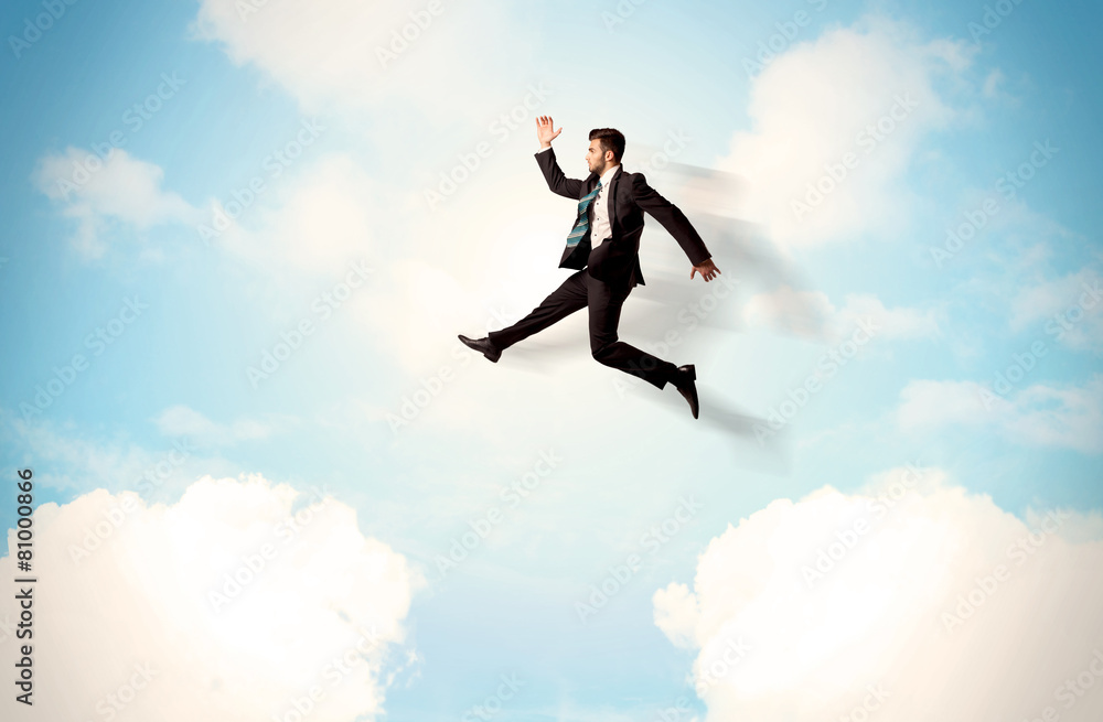 Business person jumping over clouds in the sky Business person jumping over clouds in the sky