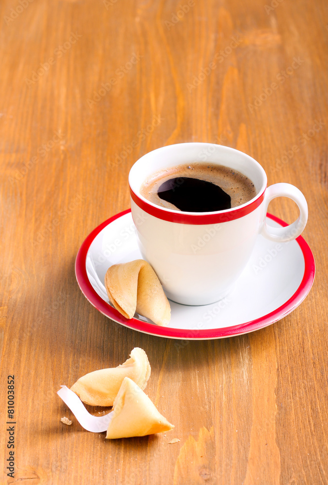 Obraz premium Cup of coffee and fortune cookie