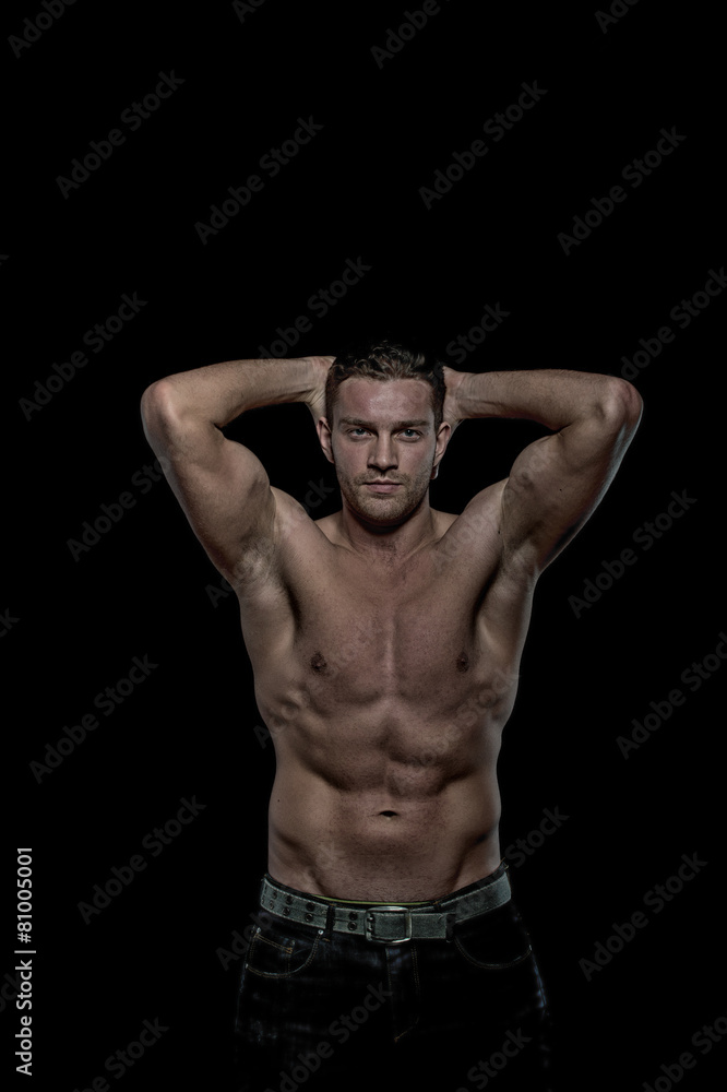 Glamour young handsome athletic man on black background Glamour young handsome athletic man on black background