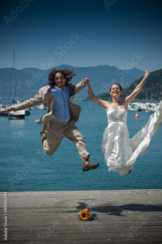 Groom and bride jumping