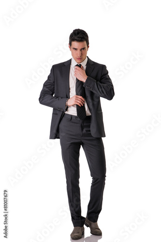 Full length shot of elegant young man with suit and neck-tie
