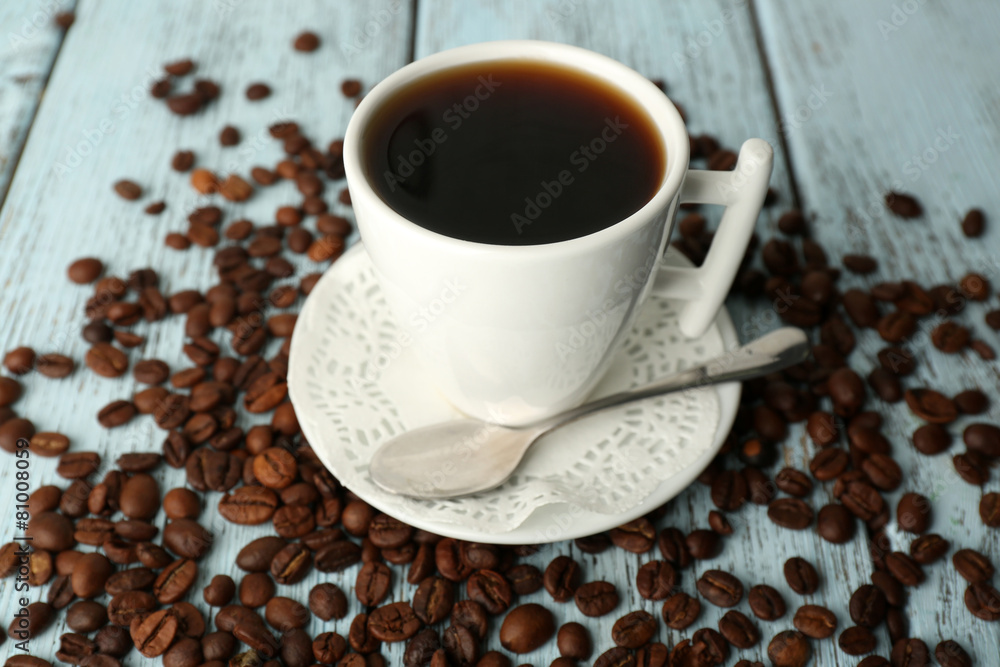 Cup of coffee with beans on color rustic wooden background Cup of coffee with beans on color rustic wooden background