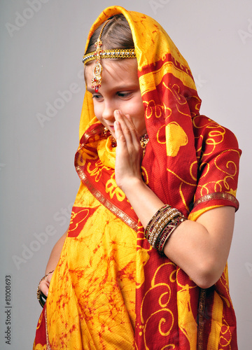 little girl in traditional Indian saree tikka and bandles photo