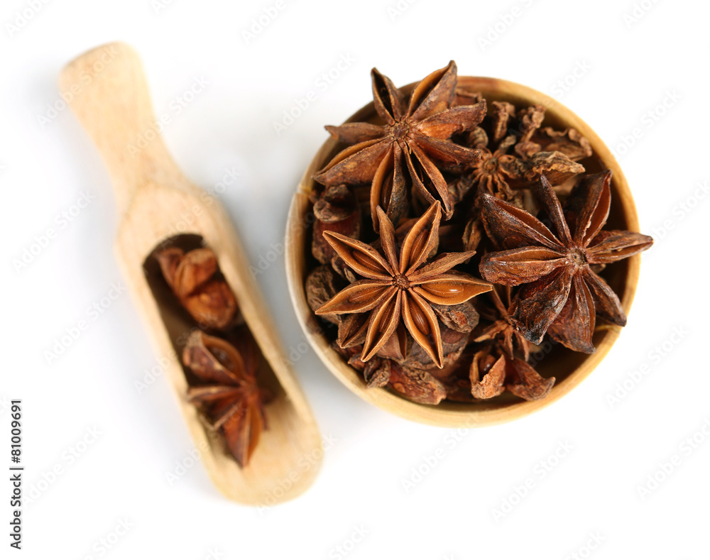 Star anise in wooden bowl, isolated on white Star anise in wooden bowl, isolated on white
