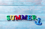Word summer on wooden background