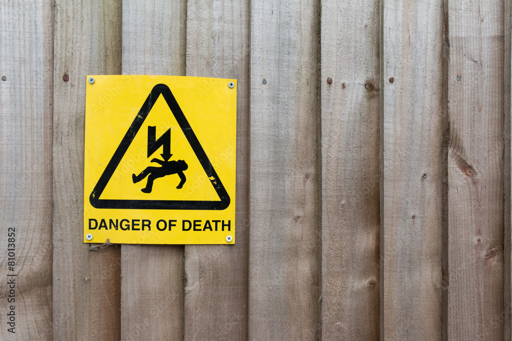 Caution Sign: Danger of Death on Wood background Caution Sign: Danger of Death on Wood background