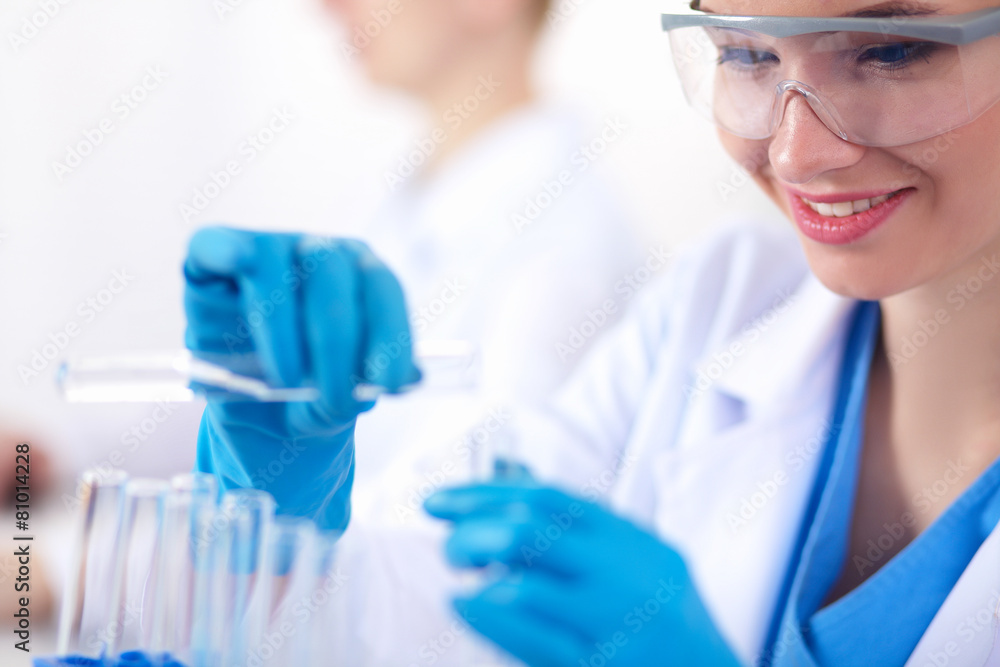 Woman researcher is surrounded by medical vials and flasks Woman researcher is surrounded by medical vials and flasks