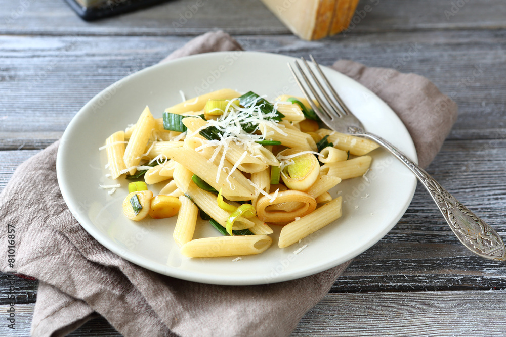 Tasty pasta with cheese and onions on a white plate Tasty pasta with cheese and onions on a white plate