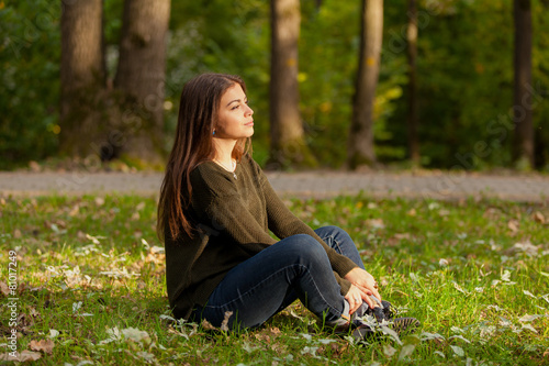 The girl meditates in park