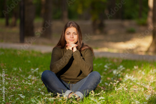 The girl meditates in park