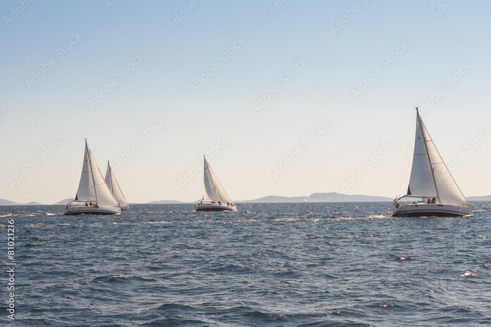 four yachts in the wind reaching a parallel course