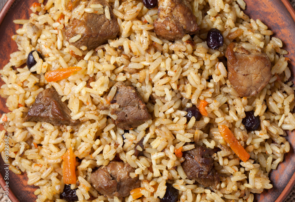 Pilaf with large pieces of fried meat, spicy rice, carrot and Pilaf with large pieces of fried meat, spicy rice, carrot and