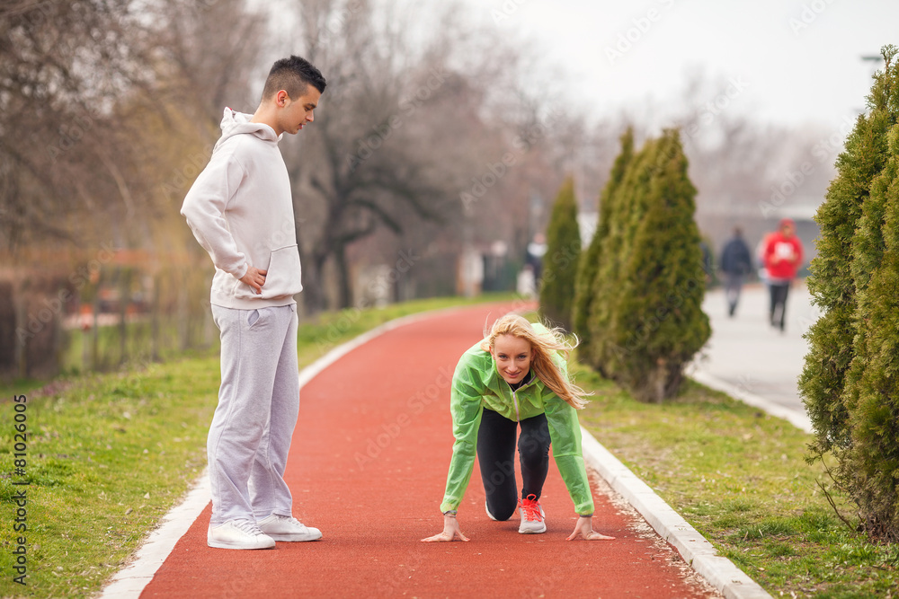 Fototapeta premium Young female athlete practicing with her coach