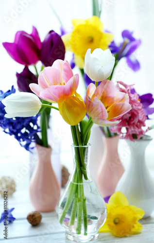 Fototapeta Naklejka Na Ścianę i Meble -  Beautiful bouquets of spring flowers on windowsill background
