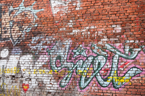  Urban brick wall with grungy chaotic graffiti