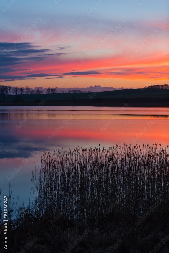 Beautiful lake with colorful sunset sky. 