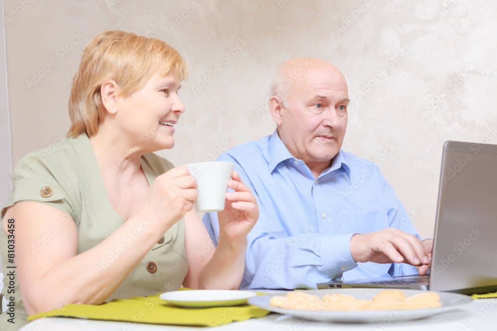 Couple using laptop at home Couple using laptop at home