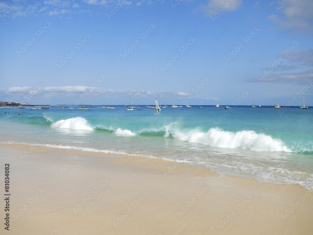 Waves breaking on tropical beach with white sand